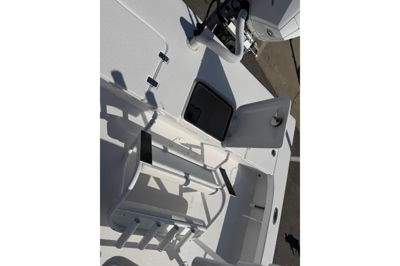 Slide: The Image of 2026 Skuta 24 Cat boat interior with open storage compartments and rod holders. - 50