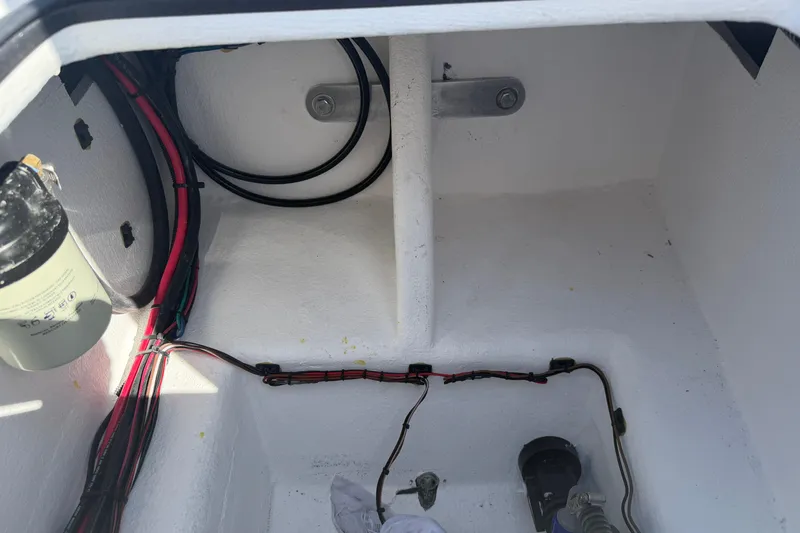 Slide: The Image of Interior view of a 2026 Skuta 24 Cat boat compartment with wiring and components. - 51