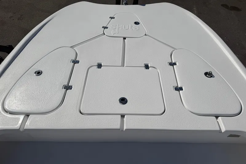 Slide: The Image of 2026 Skuta 24 Cat boat deck with storage compartments and Skuta logo. - 34