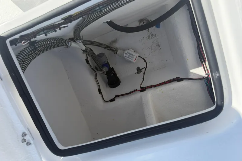 Slide: The Image of Open compartment of 2026 Skuta 24 Cat boat showing wiring and components. - 52