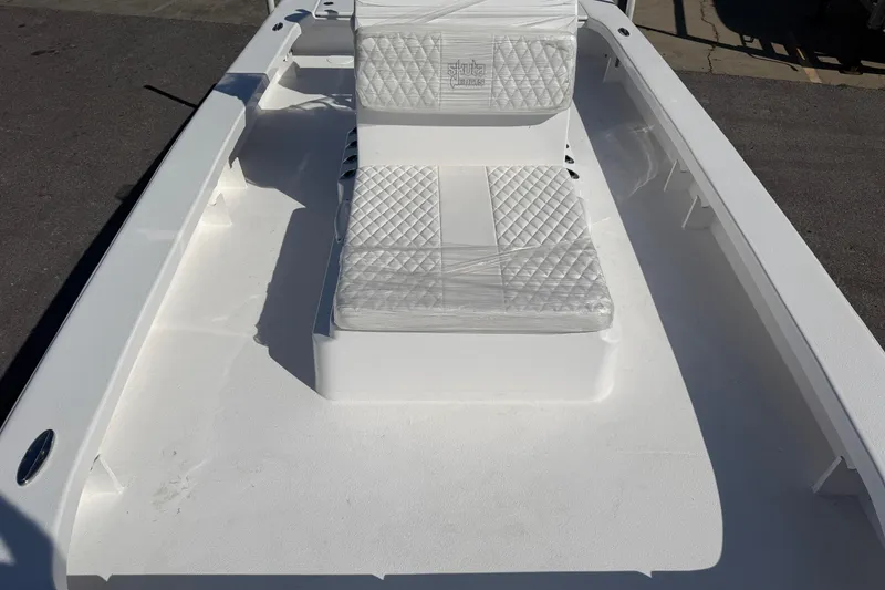 Slide: The Image of 2026 Skuta 24 Cat boat interior with white cushioned seating and sleek design. - 40