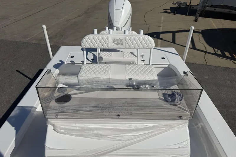 Slide: The Image of 2026 Skuta 24 Cat boat with white quilted seating and clear windshield. - 42