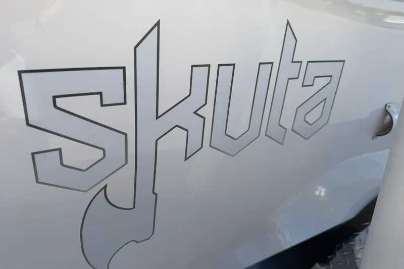 Slide: The Image of Skuta 24 Cat 2026 logo on vehicle exterior, featuring bold, angular typography. - 21