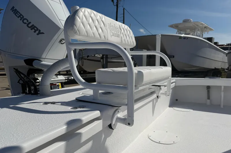Slide: The Image of 2026 Skuta 24 Cat boat with Mercury engine, featuring a white cushioned seat. - 19