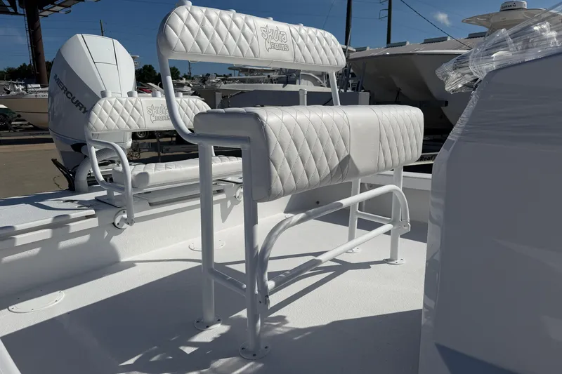 Slide: The Image of 2026 Skuta 24 Cat boat with white quilted seating and Mercury engine. - 18