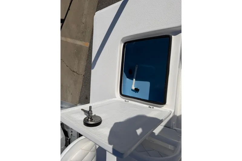 Slide: The Image of 2026 Skuta 24 Cat boat hatch with key on white surface. - 55