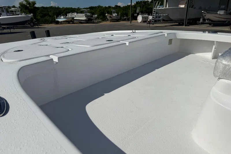 Slide: The Image of 2026 Skuta 24 Cat boat interior with white deck and storage compartments. - 10