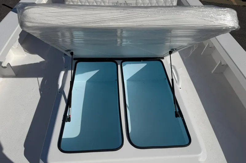 Slide: The Image of 2026 Skuta 24 Cat boat storage compartment with open hatch, revealing spacious interior. - 59