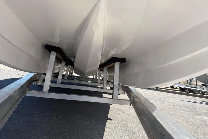Slide: The Image of Underneath view of 2026 Skuta 24 Cat boat on a trailer. - 15