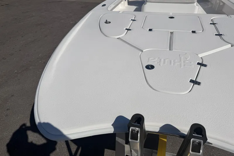 Slide: The Image of 2026 Skuta 24 Cat boat deck with storage compartments and textured surface. - 13