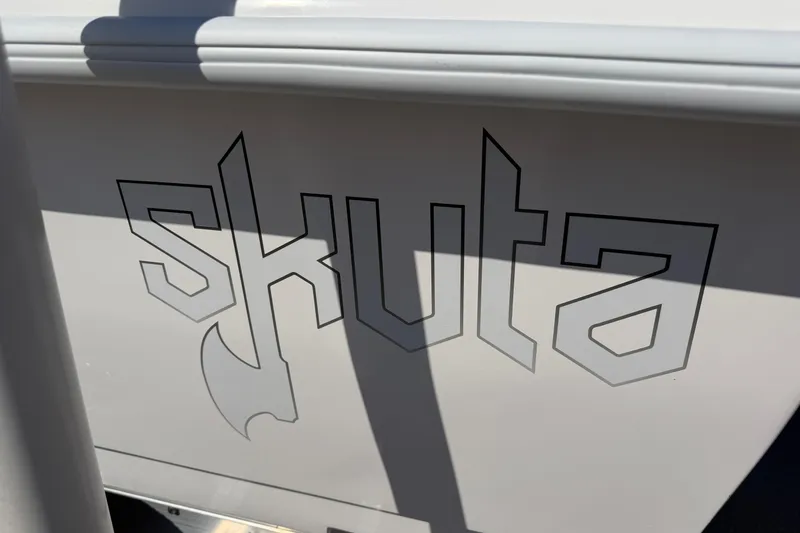 Slide: The Image of Skuta 24 Cat 2026 model logo on boat exterior, featuring bold, angular lettering. - 6