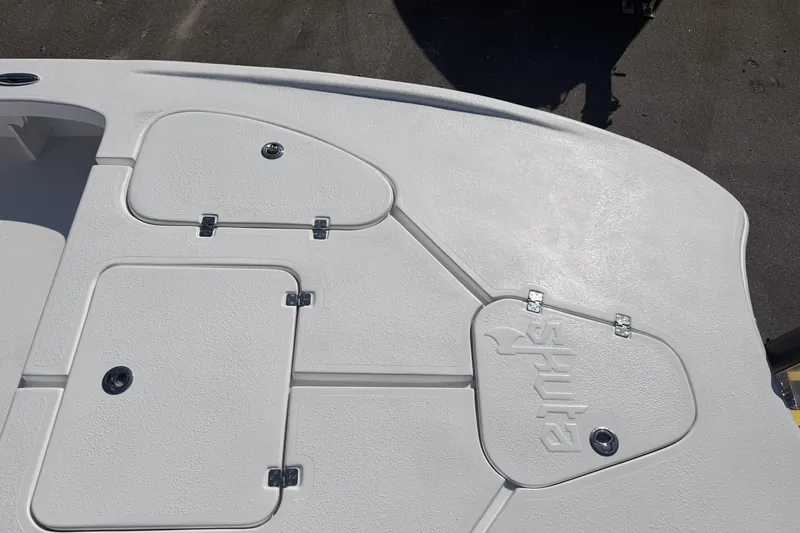 Slide: The Image of Deck view of 2026 Skuta 24 Cat boat with storage compartments and textured surface. - 37