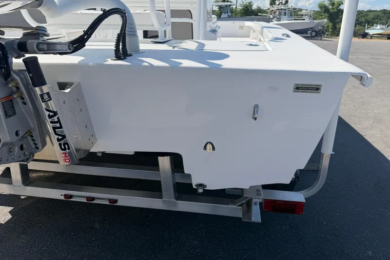 Slide: The Image of 2026 Skuta 24 Cat boat on trailer, featuring Atlas hydraulic jack plate. - 28
