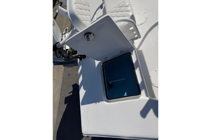 Slide: The Image of 2026 Skuta 24 Cat boat with open storage compartment and white seating. - 57