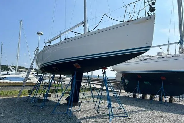 Slide: The Image of 2004 J Boats J/109 sailboat on stands, displayed outdoors in a marina setting. - 13