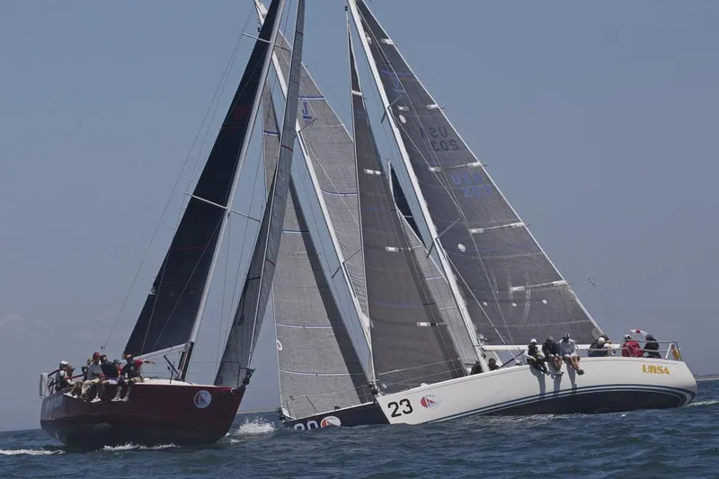 Slide: The Image of Two J/109 sailboats racing on open water, 2004 models. - 1