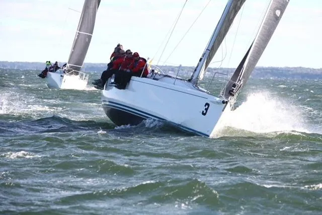 Slide: The Image of 2004 J Boats J/109 sailing in choppy waters with crew on deck. - 3