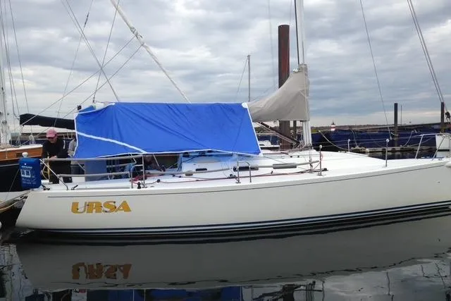 Slide: The Image of 2004 J Boats J/109 sailboat "URSA" docked with blue cover, overcast sky. - 20