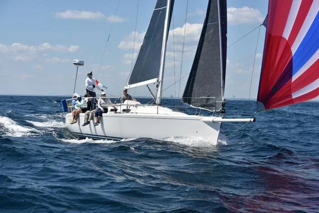 The Image of Sailing J Boats J/109, 2004 model, with colorful spinnaker on open sea. - 2