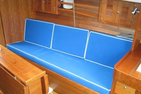 Slide: The Image of Interior of 2005 J Boats J/109 sailboat with blue cushioned seating. - 27