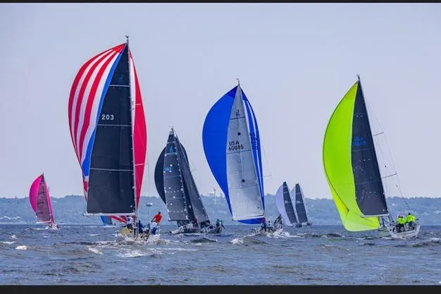 Slide: The Image of Sailboats racing with colorful spinnakers, featuring a 2004 J Boats J/109 model. - 9