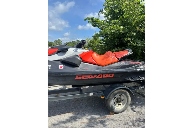 The Image of 2022 Sea-Doo GTI SE 130 jet ski with red seat on a trailer. - 3