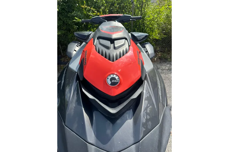 Slide: The Image of 2022 Sea-Doo GTI SE 130 jet ski, red and black, parked outdoors. - 10