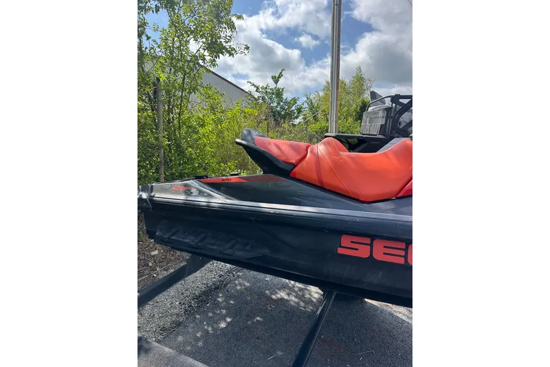 Slide: The Image of 2022 Sea-Doo GTI SE 130 jet ski with red seat, parked outdoors. - 7