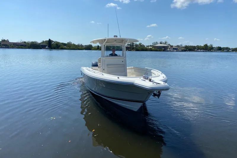 Slide: The Image of 2017 Stamas 317 Tarpon boat cruising on a calm lake under a clear blue sky. - 9