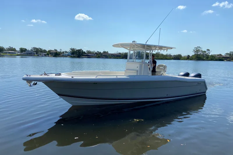 The Image of 2017 Stamas 317 Tarpon boat on calm water under clear blue sky. - 0