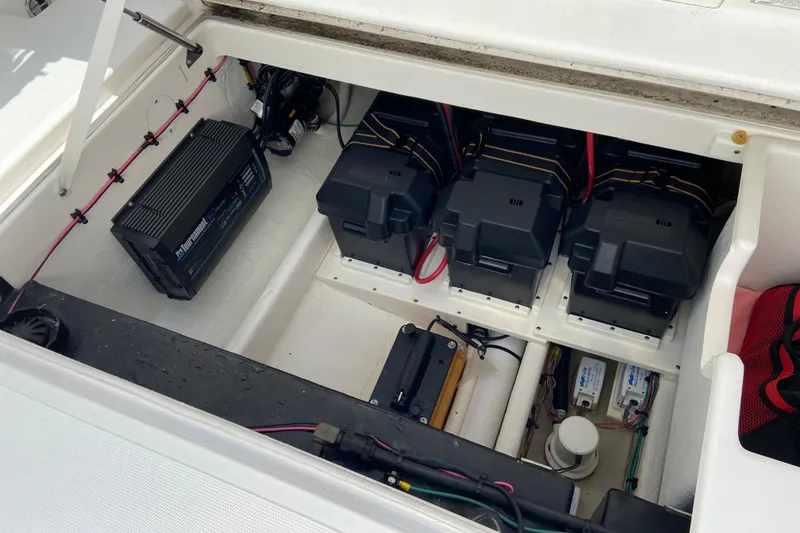 Slide: The Image of 2017 Stamas 317 Tarpon boat battery compartment with multiple batteries and wiring. - 21