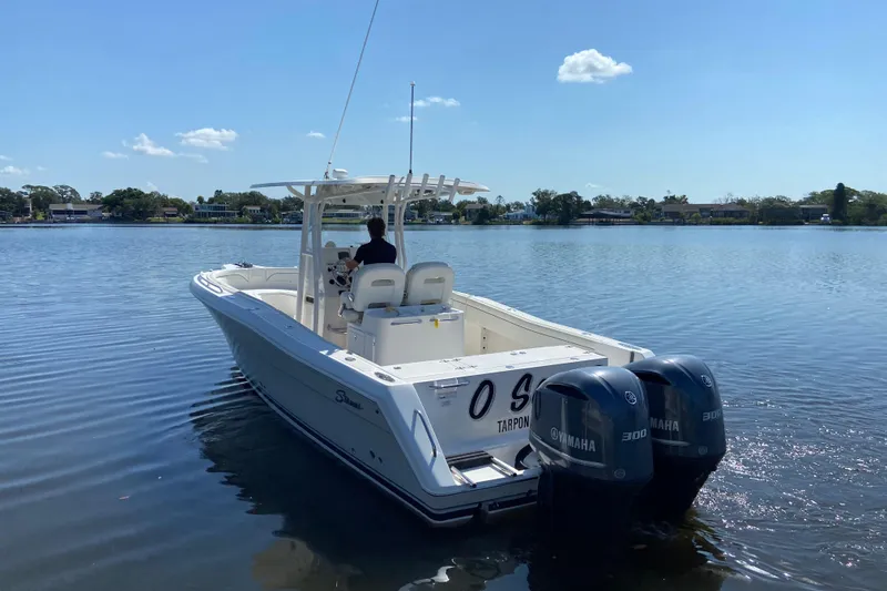 Slide: The Image of 2017 Stamas 317 Tarpon boat with dual Yamaha engines on a calm lake. - 3