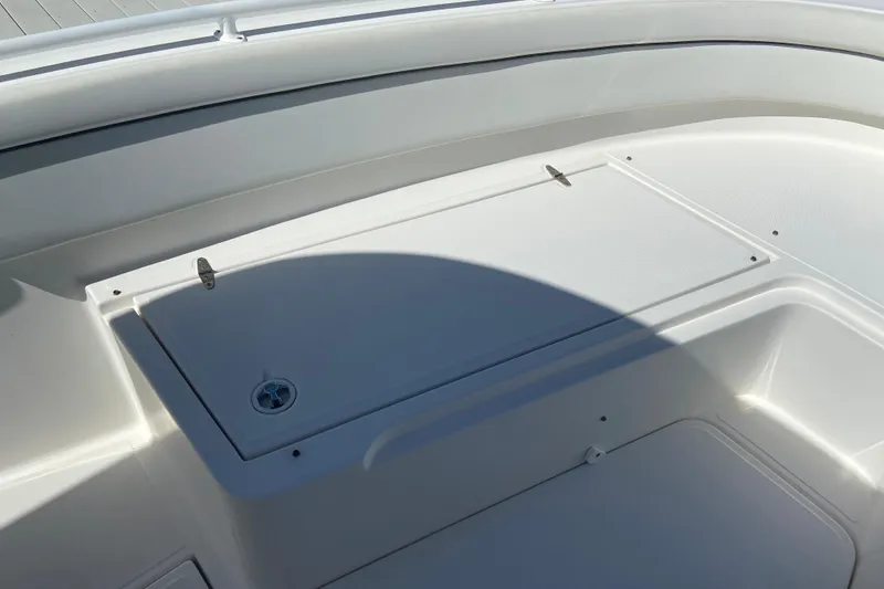 Slide: The Image of 2017 Stamas 317 Tarpon boat deck with storage compartment, featuring sleek white design. - 63