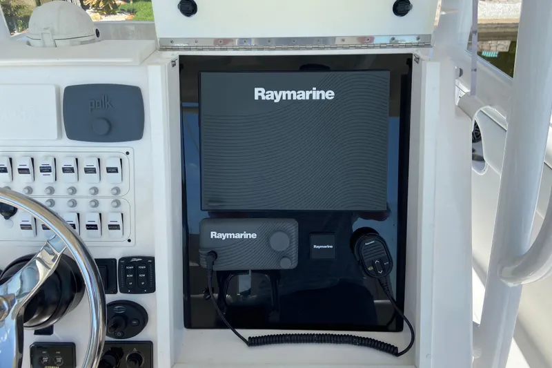 Slide: The Image of Control panel of 2017 Stamas 317 Tarpon with Raymarine electronics and Polk audio system. - 39