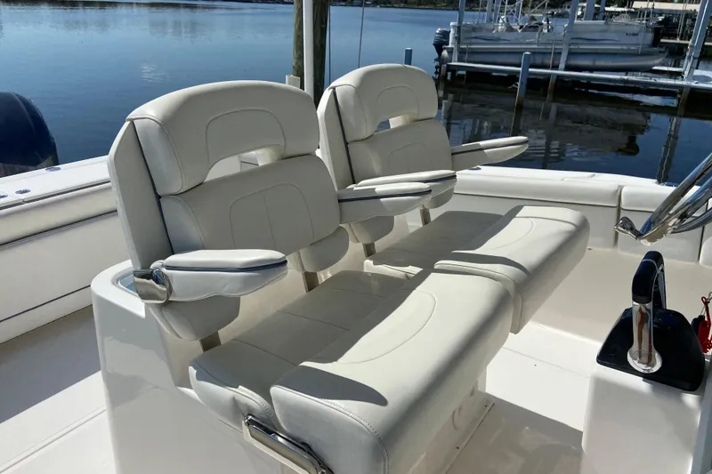 Slide: The Image of 2017 Stamas 317 Tarpon boat interior with dual white cushioned seats and armrests. - 36