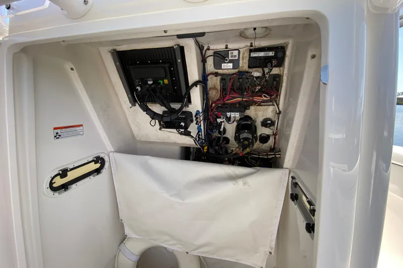 Slide: The Image of Electrical panel inside a 2017 Stamas 317 Tarpon boat, showcasing wiring and components. - 59