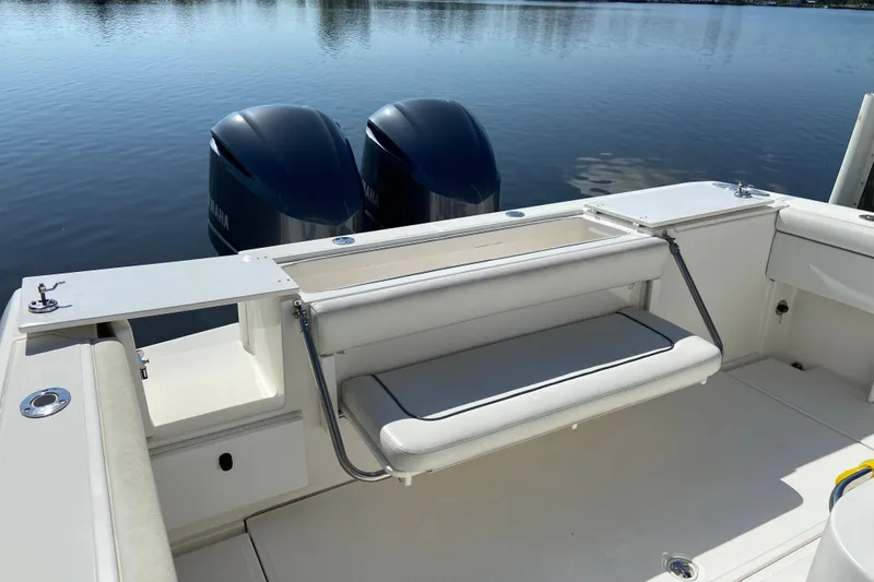 Slide: The Image of 2017 Stamas 317 Tarpon boat with dual Yamaha engines and foldable seating on calm water. - 14