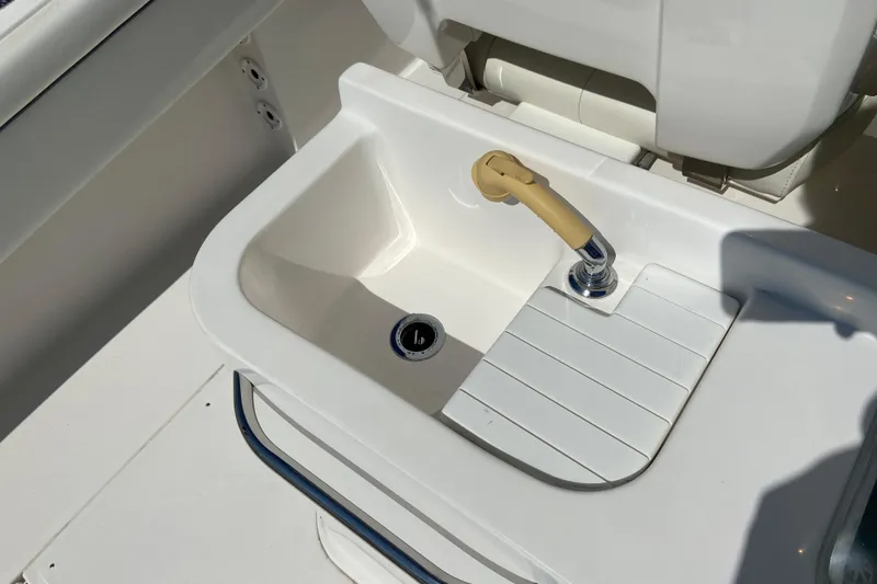 Slide: The Image of 2017 Stamas 317 Tarpon boat sink with faucet and cutting board. - 28