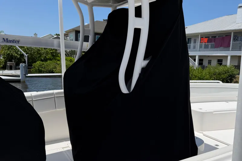 Slide: The Image of 2017 Stamas 317 Tarpon boat interior with covered seating, docked near waterfront homes. - 67