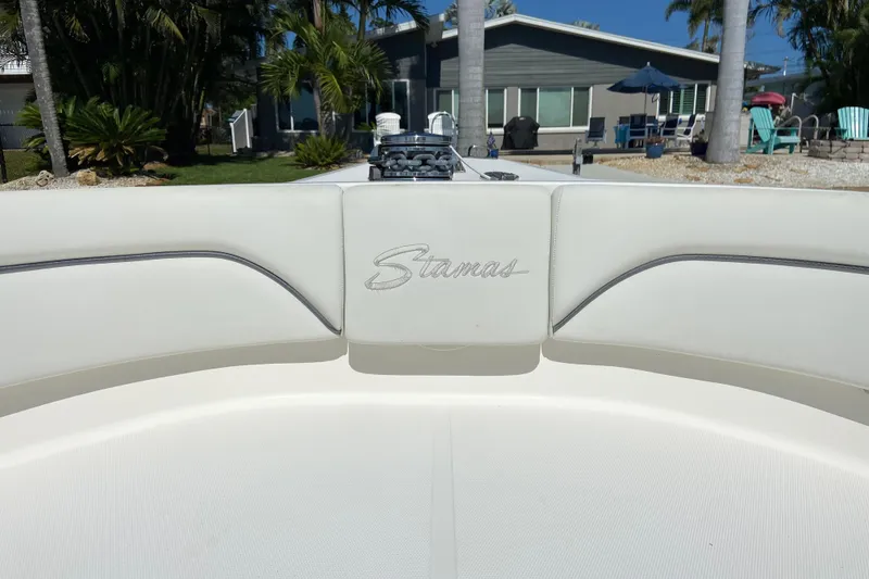 Slide: The Image of 2017 Stamas 317 Tarpon boat interior with logo, set against a tropical backdrop. - 51