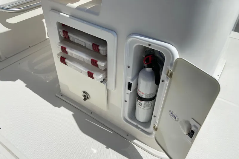 Slide: The Image of 2017 Stamas 317 Tarpon boat storage with fire extinguisher and tackle boxes. - 30