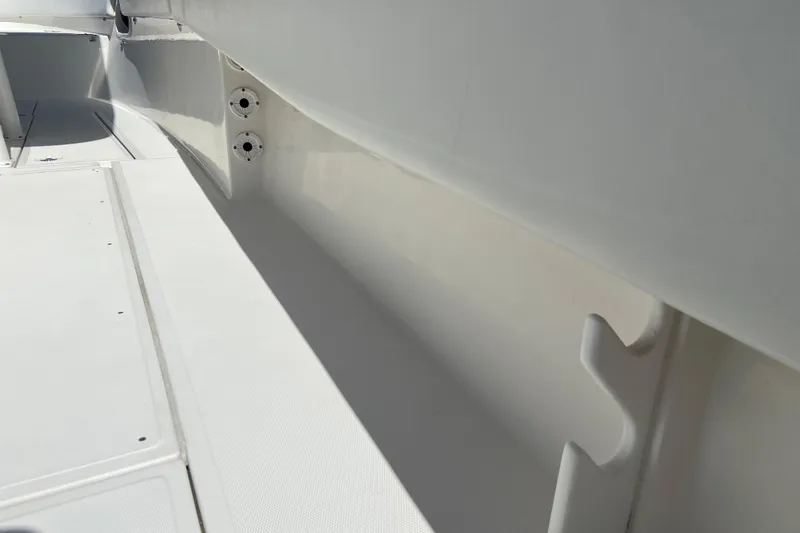 Slide: The Image of 2017 Stamas 317 Tarpon boat interior, showcasing sleek white deck and storage compartments. - 23