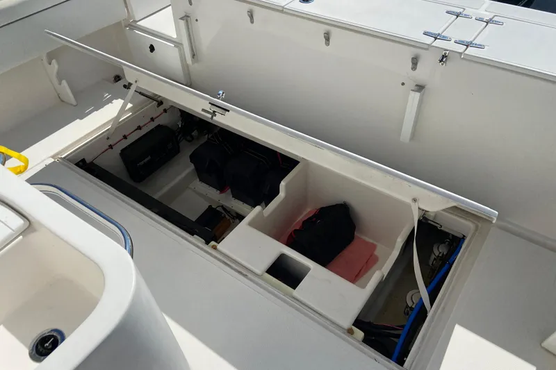 Slide: The Image of Open storage compartment on a 2017 Stamas 317 Tarpon boat, showcasing interior equipment. - 19