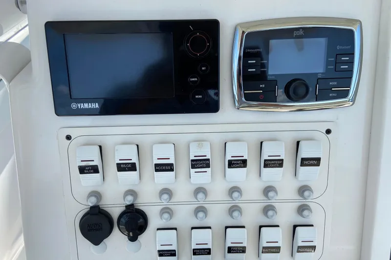 Slide: The Image of Control panel of a 2017 Stamas 317 Tarpon boat with Yamaha and Polk systems. - 41