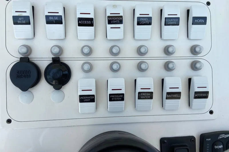 Slide: The Image of Control panel of a 2017 Stamas 317 Tarpon boat with labeled switches and ports. - 42