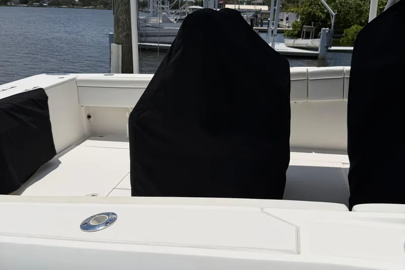 Slide: The Image of 2017 Stamas 317 Tarpon boat interior with covered seats, docked by the water. - 66