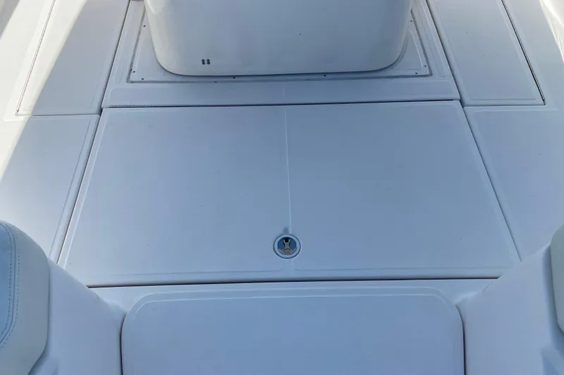 Slide: The Image of 2017 Stamas 317 Tarpon boat deck, featuring clean white surface and storage hatch. - 54