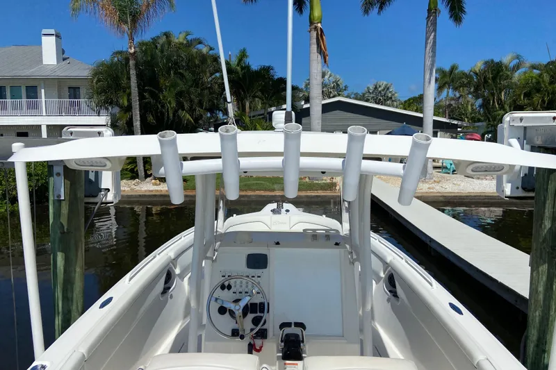 Slide: The Image of 2017 Stamas 317 Tarpon boat docked, featuring a sleek helm and rod holders. - 24