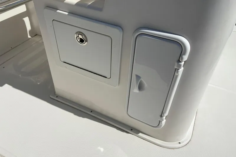 Slide: The Image of 2017 Stamas 317 Tarpon boat storage compartments with secure locks and sleek design. - 29