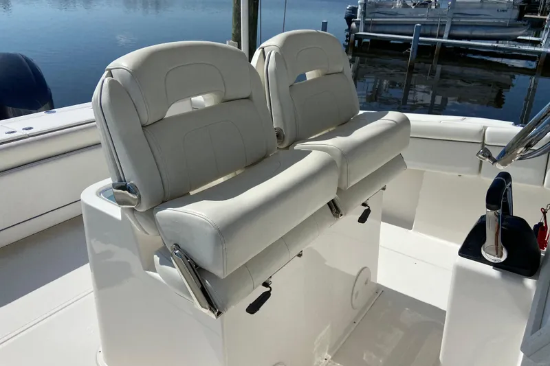 Slide: The Image of 2017 Stamas 317 Tarpon boat with dual white cushioned seats and steering console. - 35